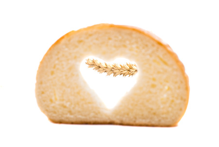 bread slice with symbol of heart isolated on white backgroundの写真素材