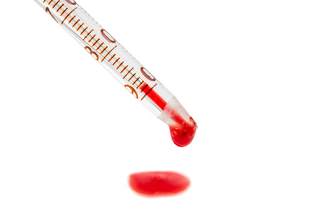 drop of blood with a pipette isolated on white backgroundの写真素材