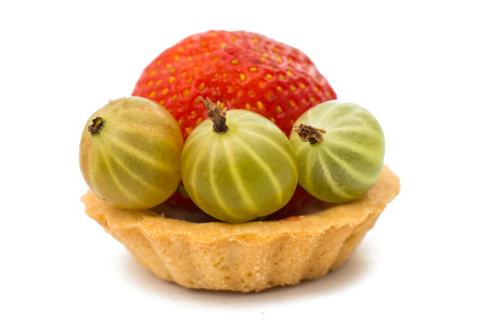 Tasty tartlet with strawberries isolated on whiteの写真素材