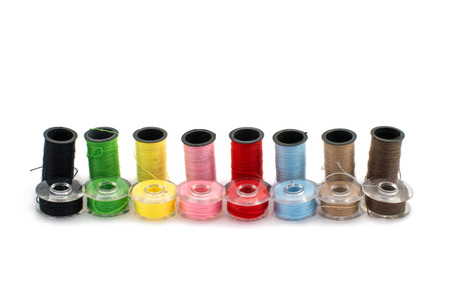 colored threads for embroidery on a white background