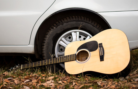 guitar near the wheels of the machineの写真素材