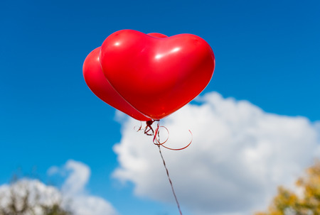 Valentine heart balloon against blue sky backgroundの写真素材