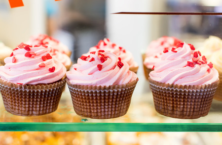 Close up set of colorful cupcakes . Chocolate Cupcake, strawberry pink, bright white vanilla. Cafe, restaurant, sweets, cakes.の写真素材