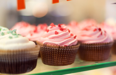 Close up set of colorful cupcakes . Chocolate Cupcake, strawberry pink, bright white vanilla. Cafe, restaurant, sweets, cakes.の写真素材