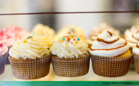 Close up set of colorful cupcakes . Chocolate Cupcake, strawberry pink, bright white vanilla. Cafe, restaurant, sweets, cakes.の写真素材