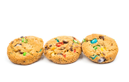 cookies with colored chocolate drops on a white backgroundの写真素材