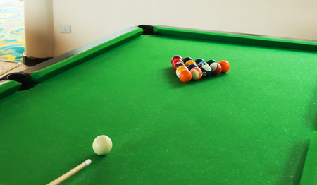 Billiard balls composition on green pool table