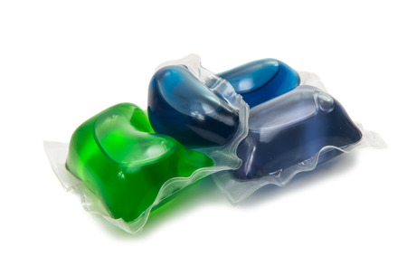 Pile of multiple washing pod capsules isolated over the whiteの写真素材