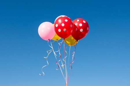 colored balloons against the blue skyの写真素材