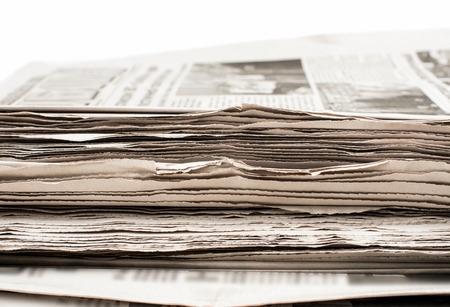 a stack of newspapers on a white backgroundの写真素材
