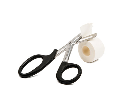 adhesive plaster with scissors isolated on white backgroundの写真素材