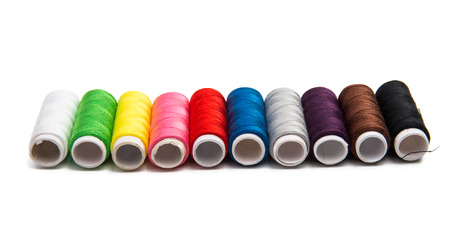 colored sewing thread isolated on white background