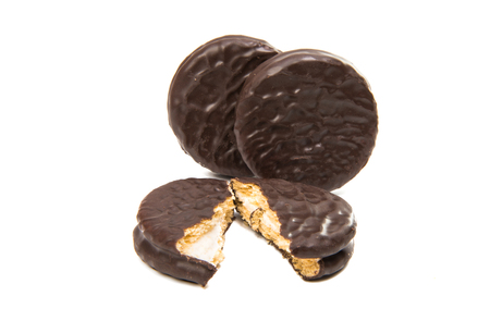 Bitten biscuit sandwich with chocolate. White backgroundの写真素材