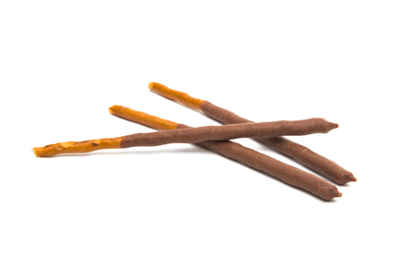 chocolate dipped cookie sticks on white background.の写真素材