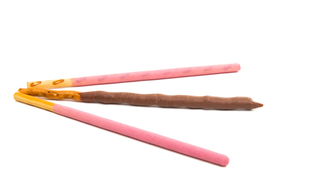 chocolate dipped cookie sticks on white backgroundの写真素材