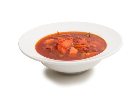 a plate with a beetroot soup isolated on a white backgroundの写真素材