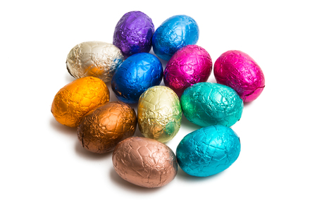 chocolate eggs in foil isolated on white backgroundの写真素材