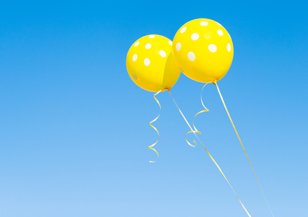 balloons against the blue skyの写真素材