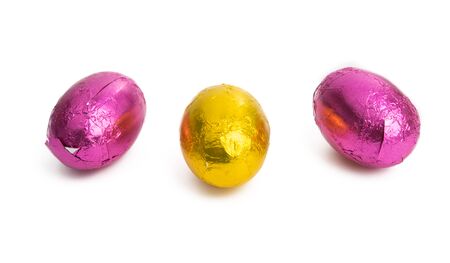 Easter chocolate eggs in foil on white backgroundの写真素材