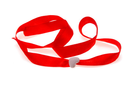 red ribbon with heart isolated on white backgroundの写真素材