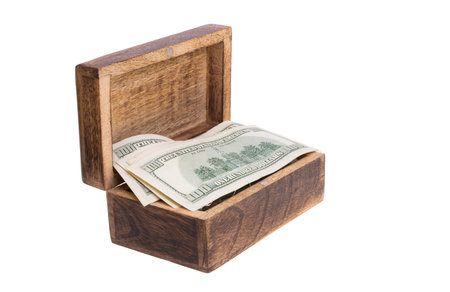 dollars in a wooden box isolated on a white background