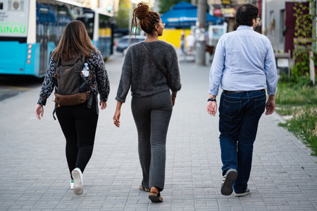 students walking on the sidewalk in the cityの写真素材