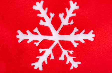 red festive background with white snowflakeの写真素材