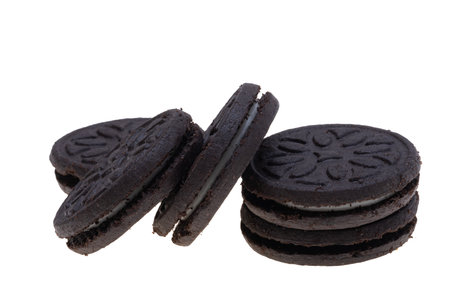 black sandwich biscuits isolated on white backgroundの素材
