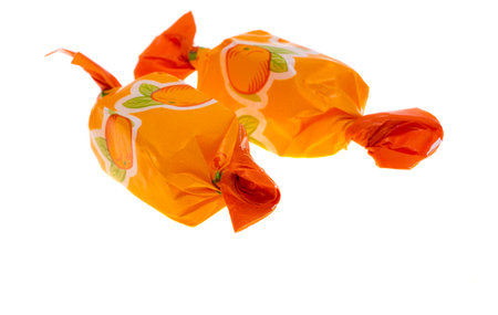 fruit candies in a wrapper isolated on white backgroundの素材