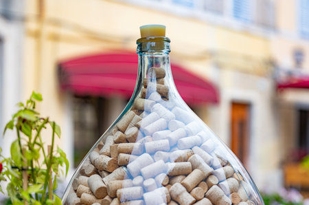 many wine corks in a glass bottle