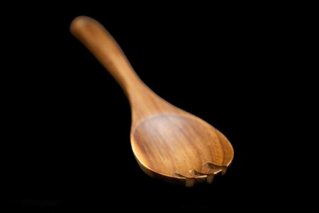 wooden kitchen spatulas on a black backgroundの写真素材