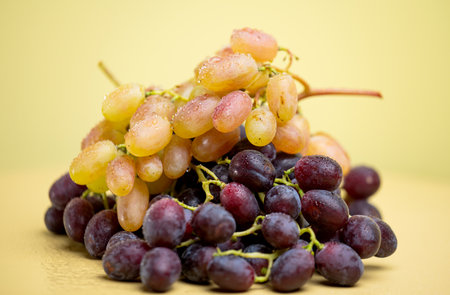 bunches of grapes on a yellow background