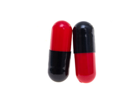 red black capsules isolated on white backgroundの写真素材
