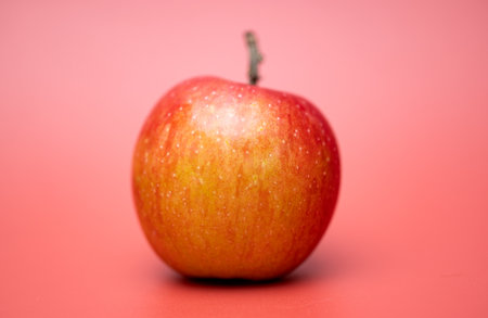 red apple on a red background