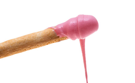 biscuit stick with pink cream isolated on white backgroundの写真素材