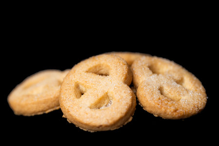 butter cookies isolated on black backgroundの写真素材