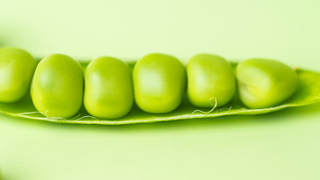 young green pea pods close up