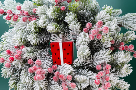 christmas decoration with fir branches in snow and gift