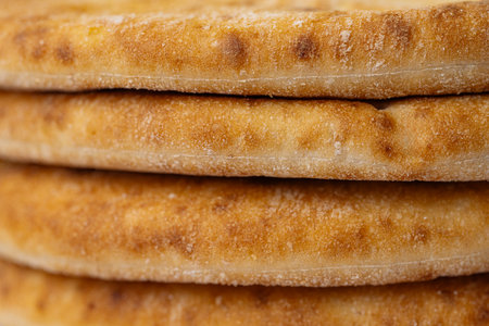 a close-up of a stack of Greek flatbreads