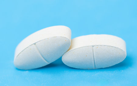 white pills on a blue backgroundの写真素材