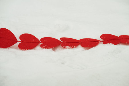 red hearts on the snow close-up