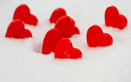 red hearts on the snow close-up