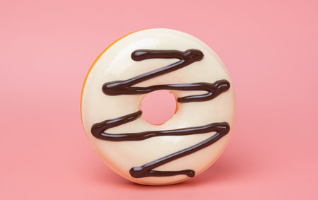 Close-up of glazed donuts on a pink background