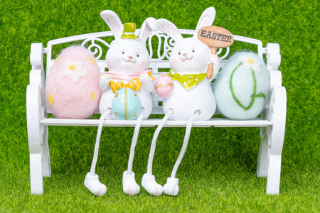 Easter bunny with eggs on a green background