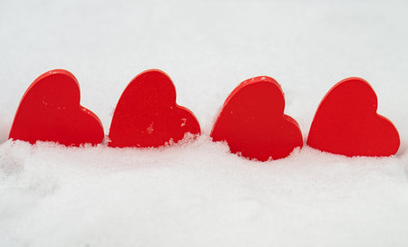 red hearts on the snow close-up