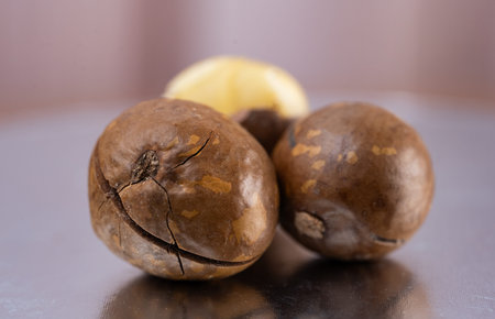 Whole unpeeled macadamia nuts close up