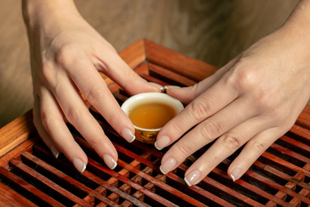Close-up table for a tea ceremony utensils in the hands of a tea setの写真素材