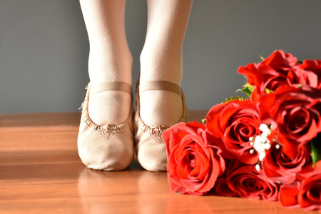 Little girl ballet shoes with rose bouquet.の写真素材