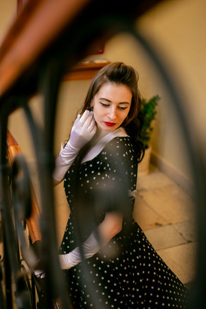 Moscow, 2019, GUM, Red Square. Photo shoot in retro style. A girl in a retro polka dot dress, white gloves and a veil on Moscow's red Square. Photo shoot in the style of the 80s and 90s.のeditorial素材