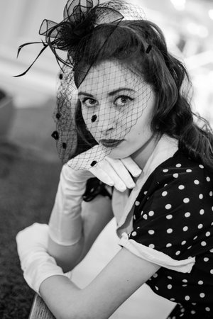 Moscow, 2019, GUM, Red Square. Photo shoot in retro style. A girl in a retro polka dot dress, white gloves and a veil on Moscow's red Square. Photo shoot in the style of the 80s and 90s.のeditorial素材